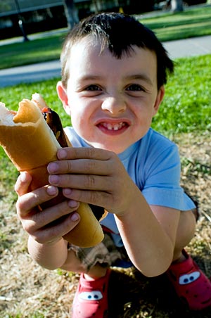 kid eats hot dog